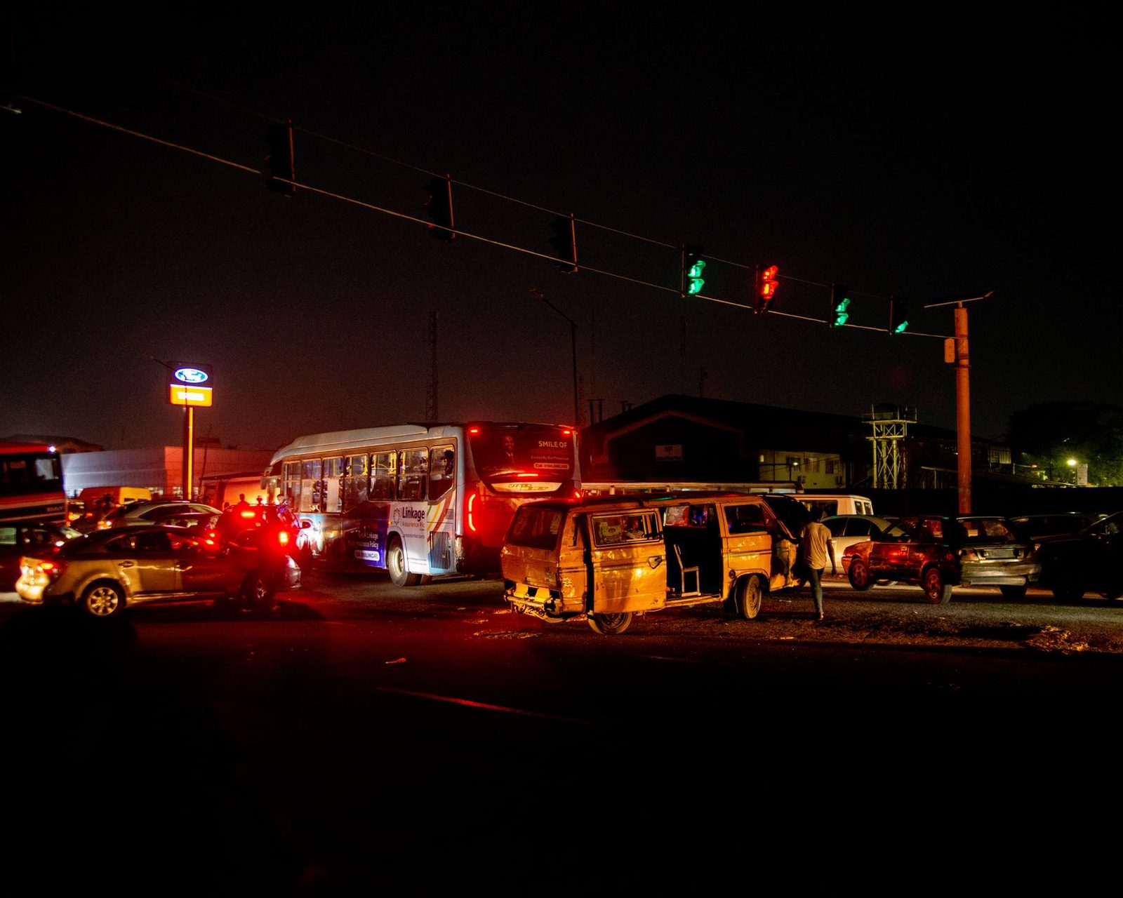 Multi-vehicle collision at busy urban intersection at night.