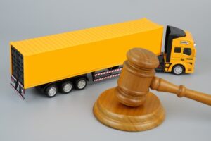 A yellow color truck model with judge's gavel
