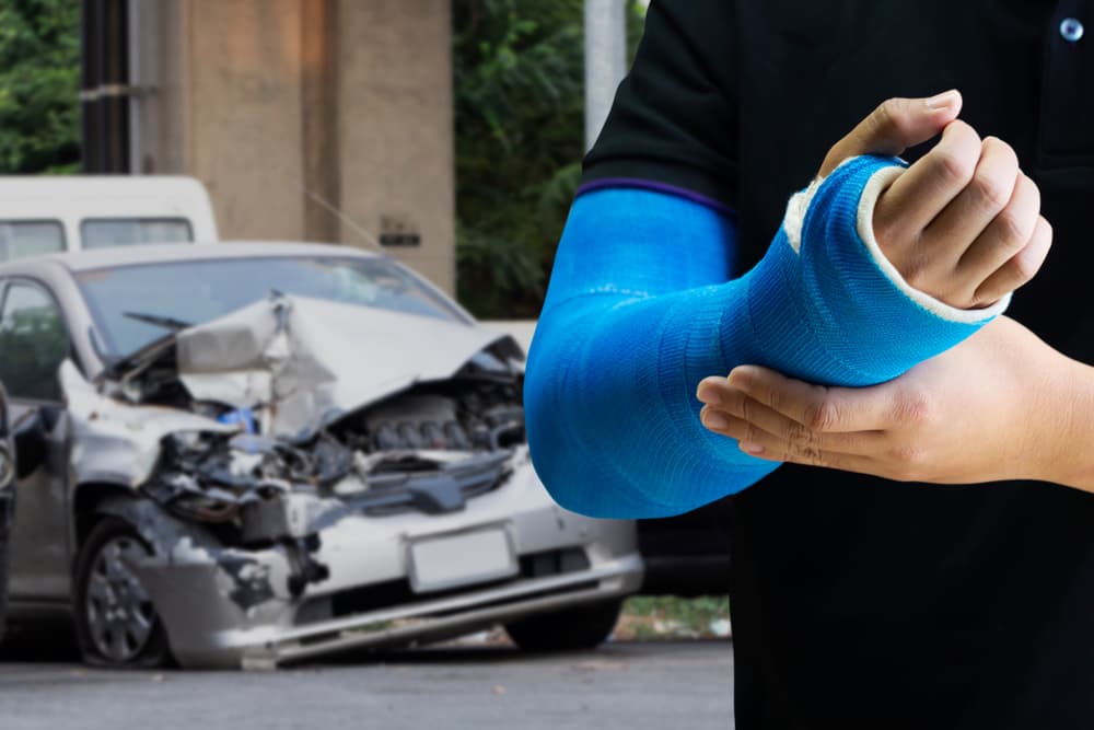 Close up man holding hand with blue bandage